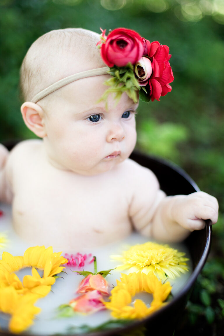 baby girl in floral milk bath