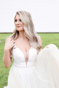 Gorgeous Texas bride holding up her wedding dress. Houston wedding photography.