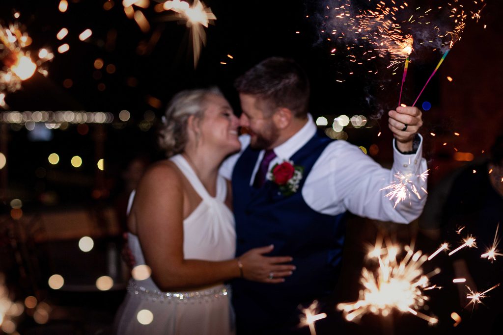 Texas bride and groom kissing under sparklers. Wedding photography. Sparkler photograph.